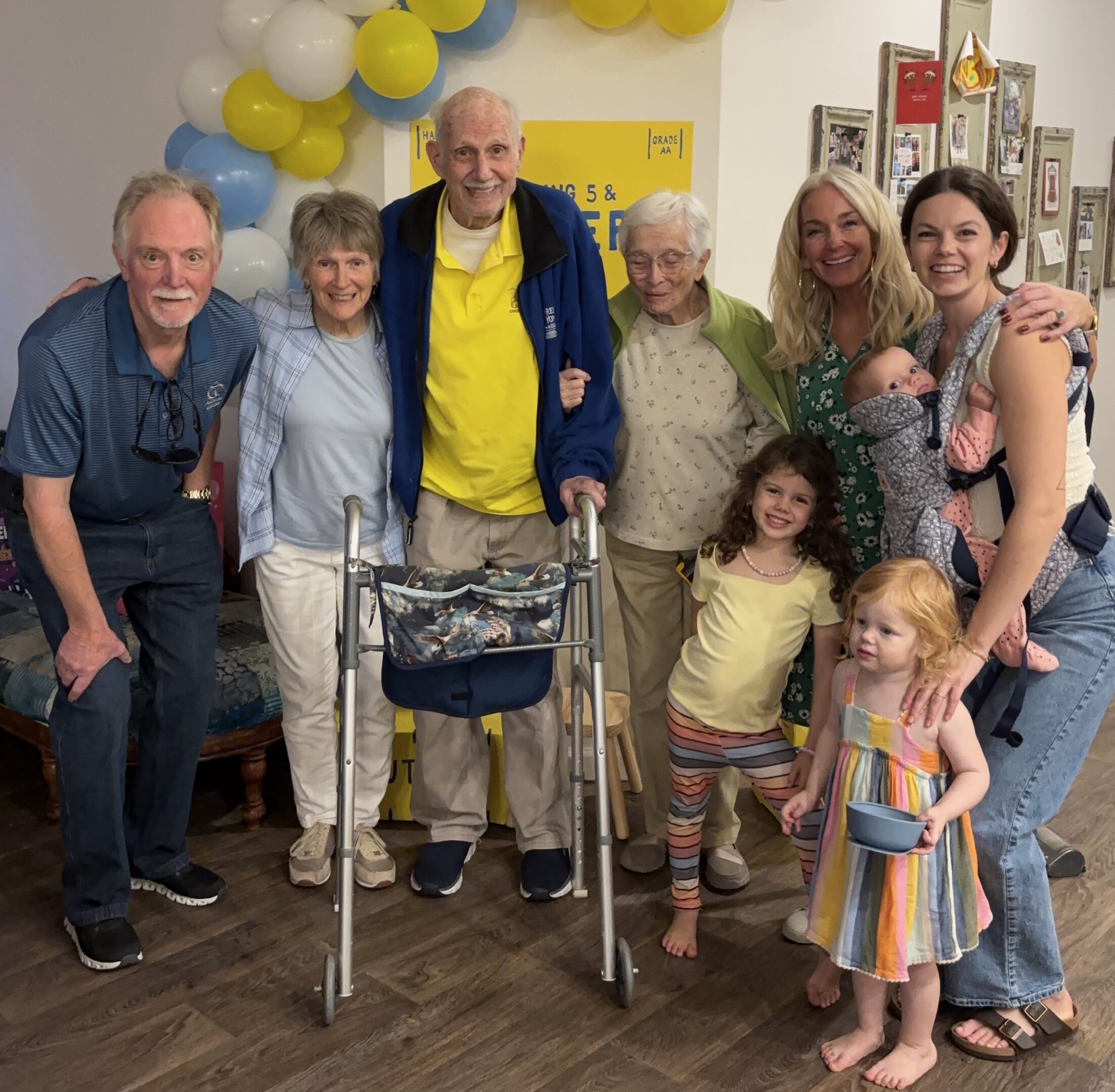 Smiling multigenerational family posing with walker
